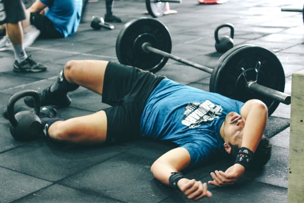 Man feeling exhausted during intensive body bulking workout