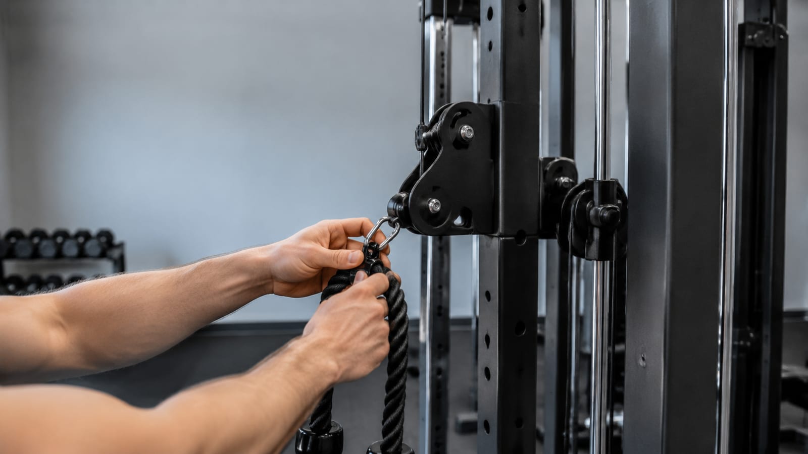 Hands attaching rope handle to mid-height cable carabiner