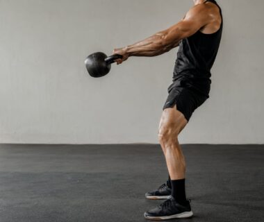 Athlete swinging a kettlebell hard during high intensity training