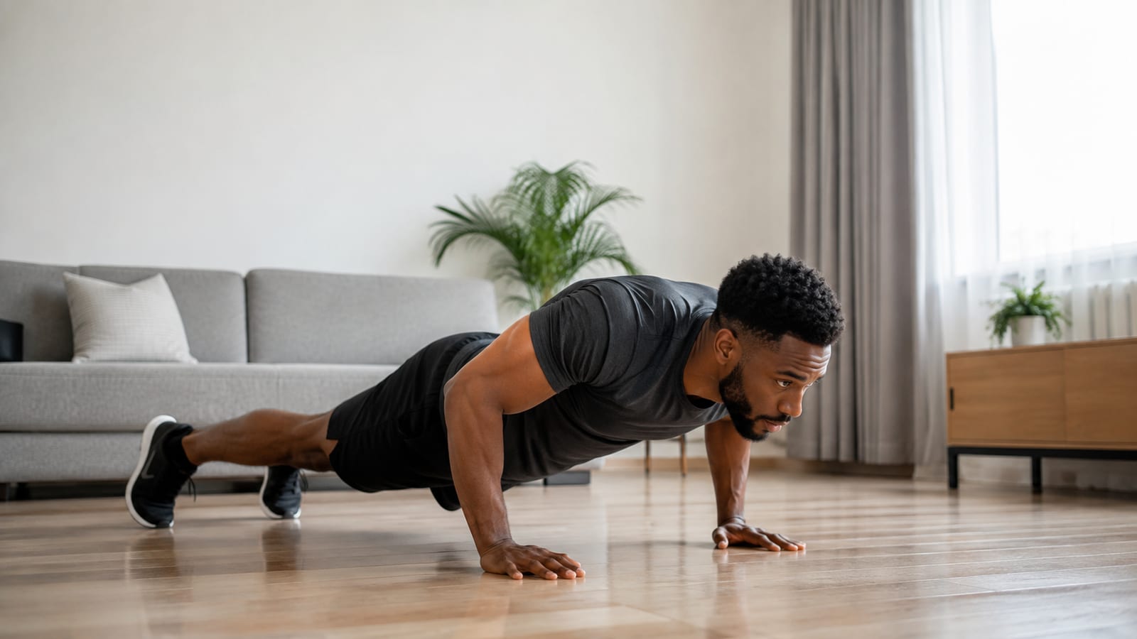 Athlete performing push-ups on a clear floor during a focused bodyweight strength session